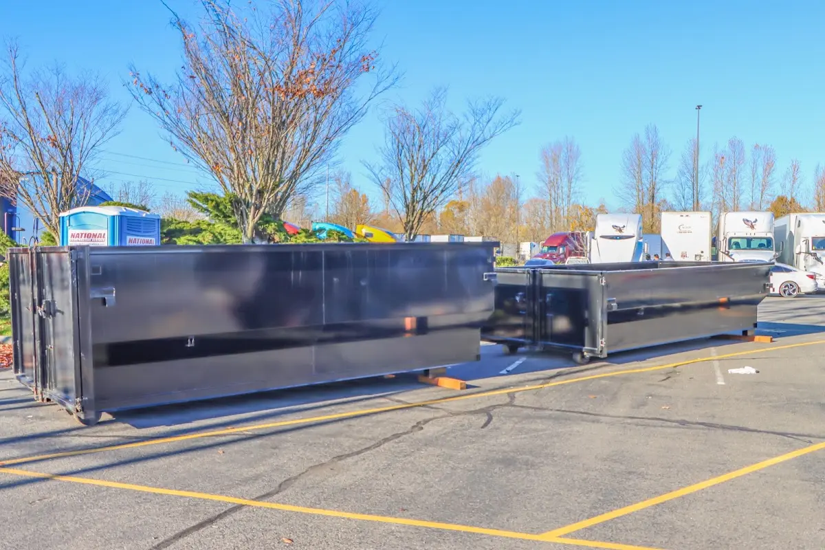 Professional dumpster rental service with roll-off container on residential driveway in Nogales